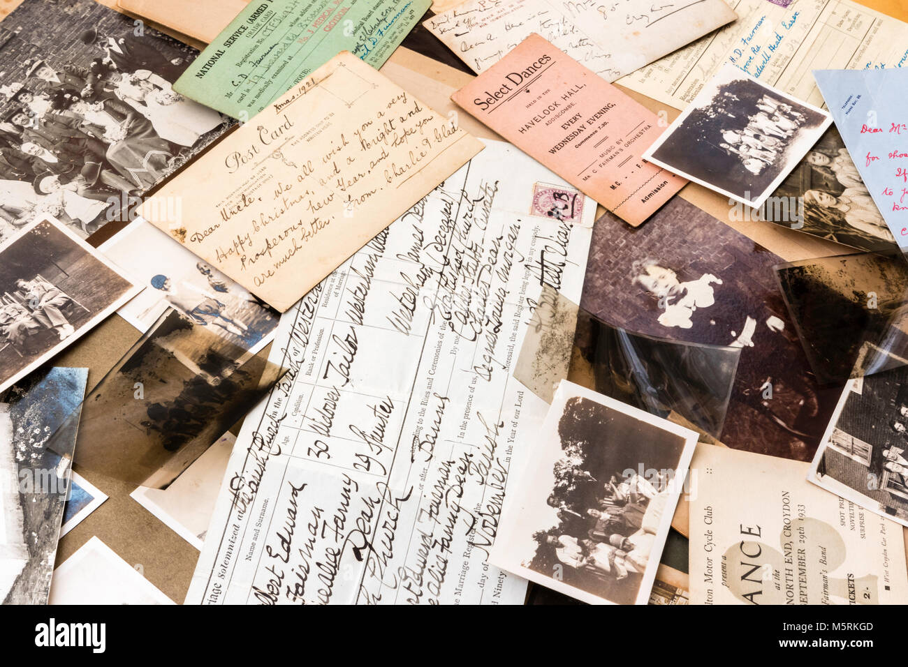 Genealogy and memorabilia. 1900-1920 Photographs, negatives, postcards, birth certificate, dance tickets, letters scattered. Family history items. Stock Photo