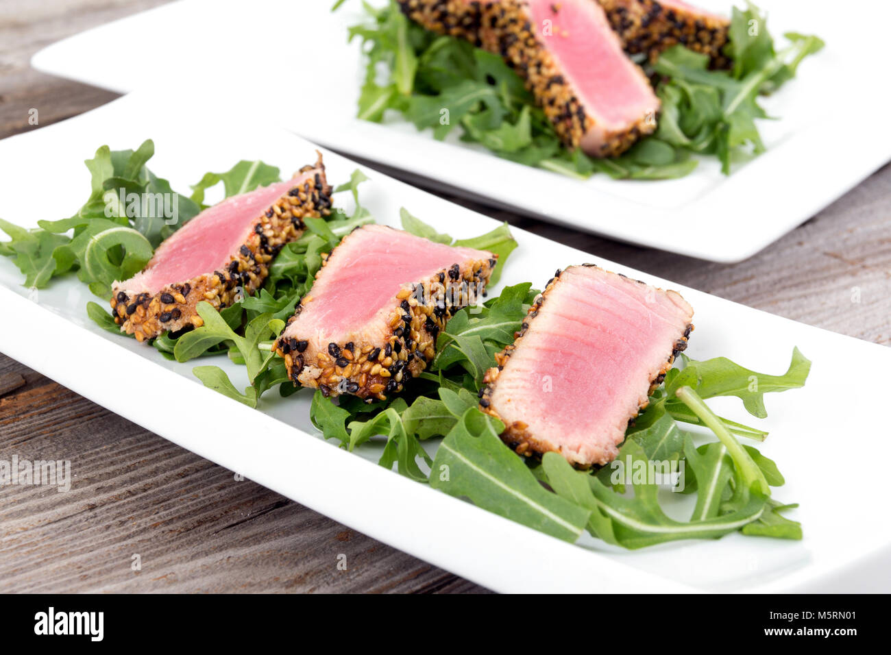 tuna tataki sesame crust appetizer plate over wood backgroung Stock