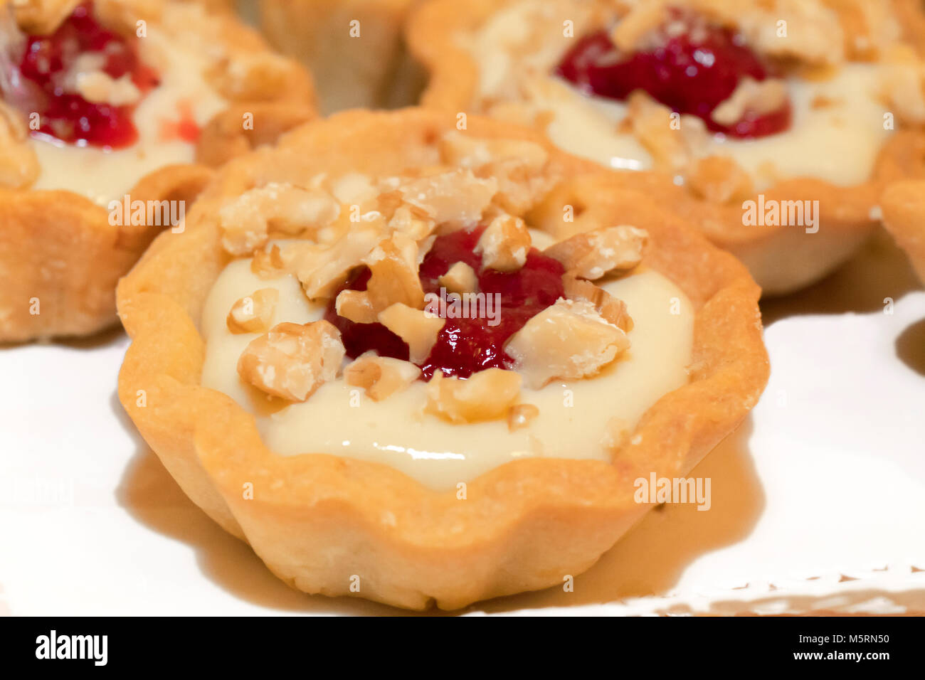 Italy gastronomy basket short pastry with orange cream and a drop of strawberry jam Stock Photo