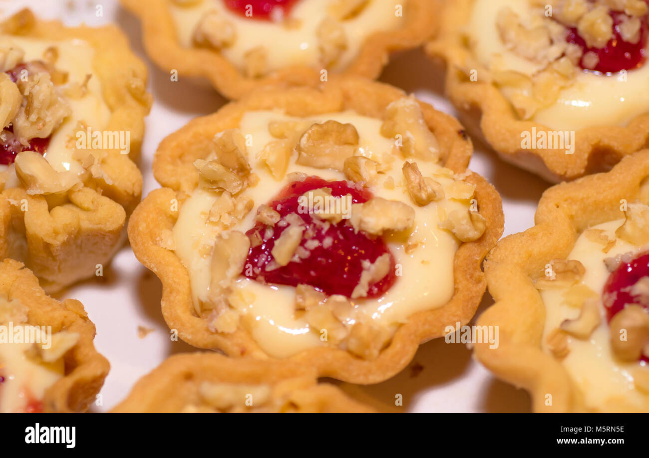 Italy gastronomy basket short pastry with orange cream and a drop of strawberry jam Stock Photo