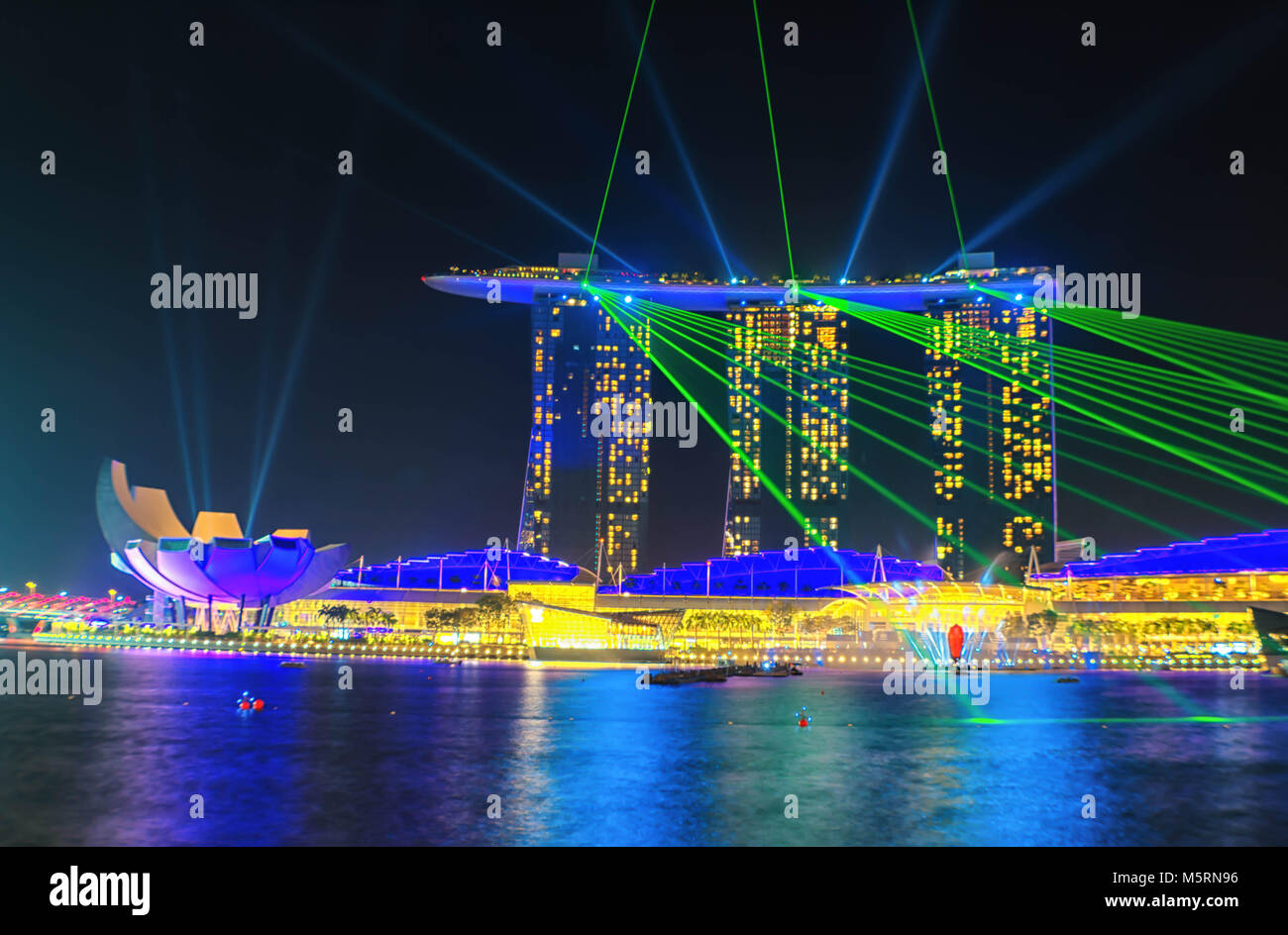 View at the Marine Bay in Singapore during its light show with its light reflecting on the river Stock Photo