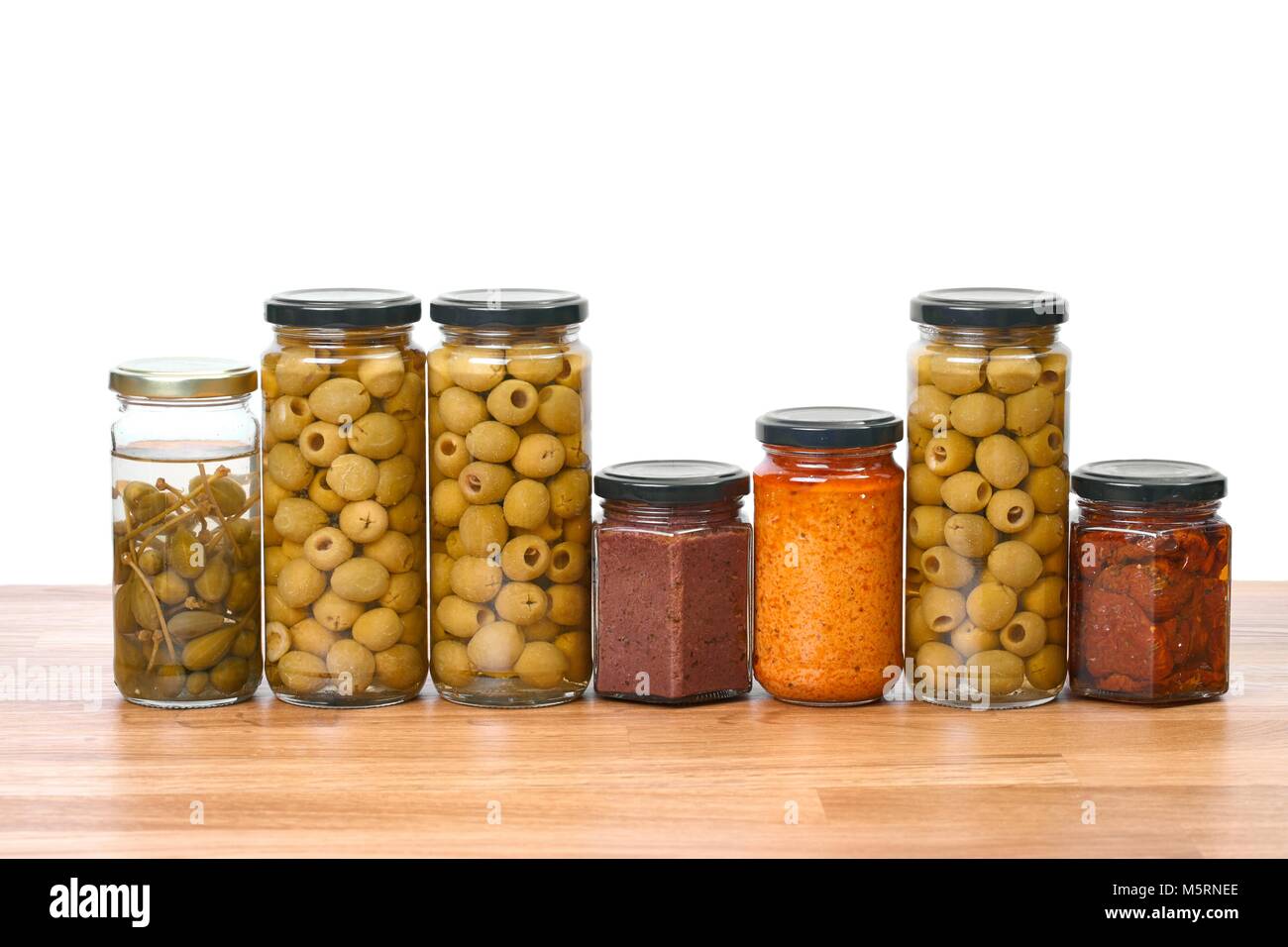 Jars of olives, pesto, dried tomatoes, caper on a shelf Stock Photo Alamy