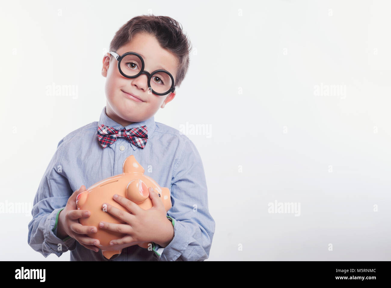 smiling boy with a piggy bank Stock Photo - Alamy