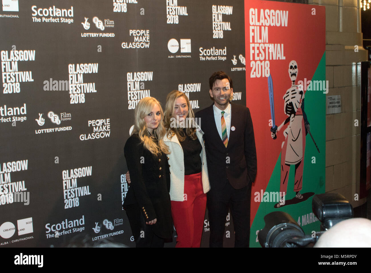 Glasgow, Scotland, UK. 25th February, 2018. Actor, David Tennant on the red carpet, with Georgia Moffett (Producer) and Daisy Aitkens (Director), at a photo call for the European film premiere of You, Me and Him, at the Glasgow Film Theatre (GFT), Scotland. You, Me and Him is 'a fizzy Bridget-Jones-style romp,' and co-starring are Faye Marsay and Lucy Punch. This screening is part of the Local Heroes strand at the Glasgow Film Festival 2018 (GFF), which runs until 4th March, 2018. Iain McGuinness / Alamy Live News Stock Photo