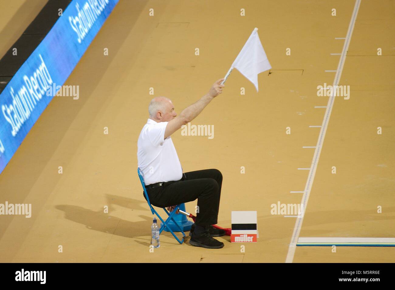 Glasgow, Scotland, 25 February 2018. An athletics official raising a