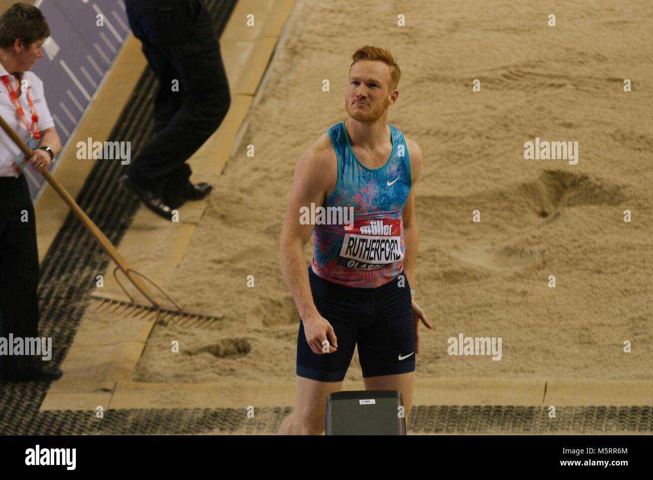 Glasgow, Scotland, 25 February 2018. Greg Rutherford checks the big screen after jumping in the long jump at the Muller Indoor Games in Glasgow. Credit: Colin Edwards/Alamy Live News. Stock Photo