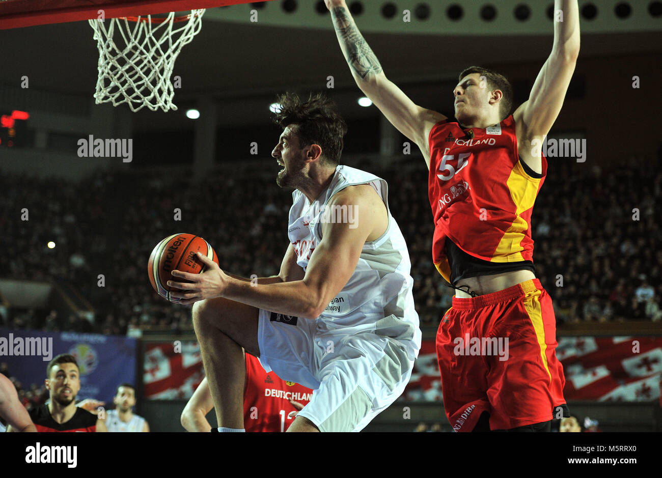 (180226)-- TBILISI, Feb 26, 2018 (Xinhua) -- Georgia's N.Tskitishvili (L) goes to the basket under the defense of Germany's I. Hartenstein during the match of the FIBA Basketball World Cup 2019 European qualifier in Tbilisi, Georgia, on Feb 25, 2018. Germany won 87-77. (Xinhua/Kulumbegashvili Tamuna) Stock Photo