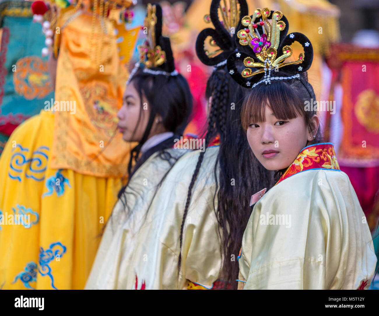 Paris, France. 25th Feb, 2018. Environmental portrait of an unidentified Chinese girl looking back during the 2018 Chinese New year parade in Paris. Credit: Radu Razvan/Alamy Live News Stock Photo