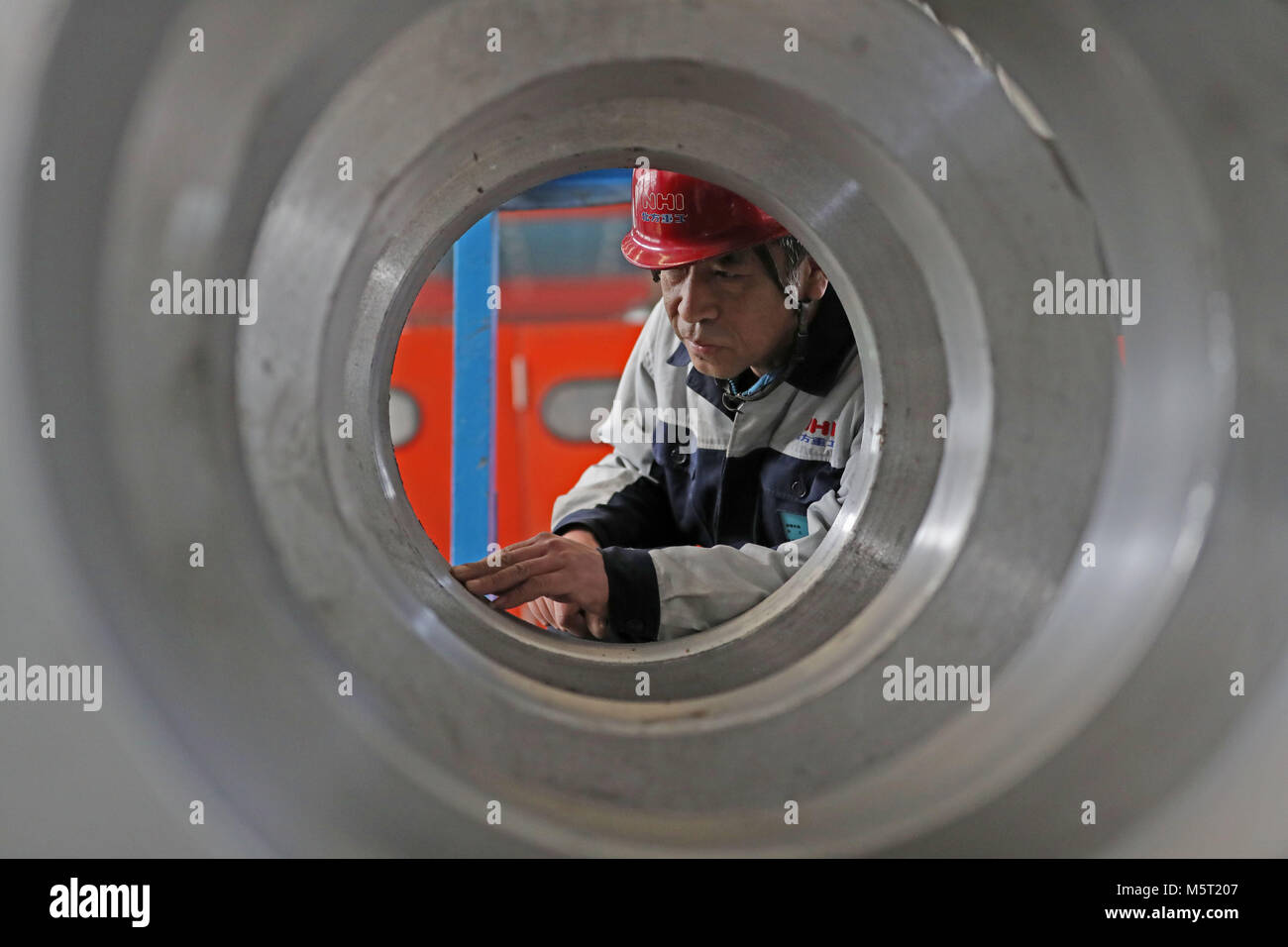 (180226) -- BEIJING, Feb. 26, 2018 (Xinhua) -- Mi Zhongyi, newly-elected deputy to the 13th National People's Congress, works at a workshop of Transmission Equipment Company of Northern Heavy Industries Group Co., Ltd. in Shenyang, northeast China's Liaoning Province, Feb. 23, 2018. Mi said that workers' attention to detail provides the foundation for innovation. China's annual political sessions of the National People's Congress (NPC) and the National Committee of the Chinese People's Political Consultative Conference (CPPCC) are scheduled to convene in March, 2018. During the two sessions, d Stock Photo