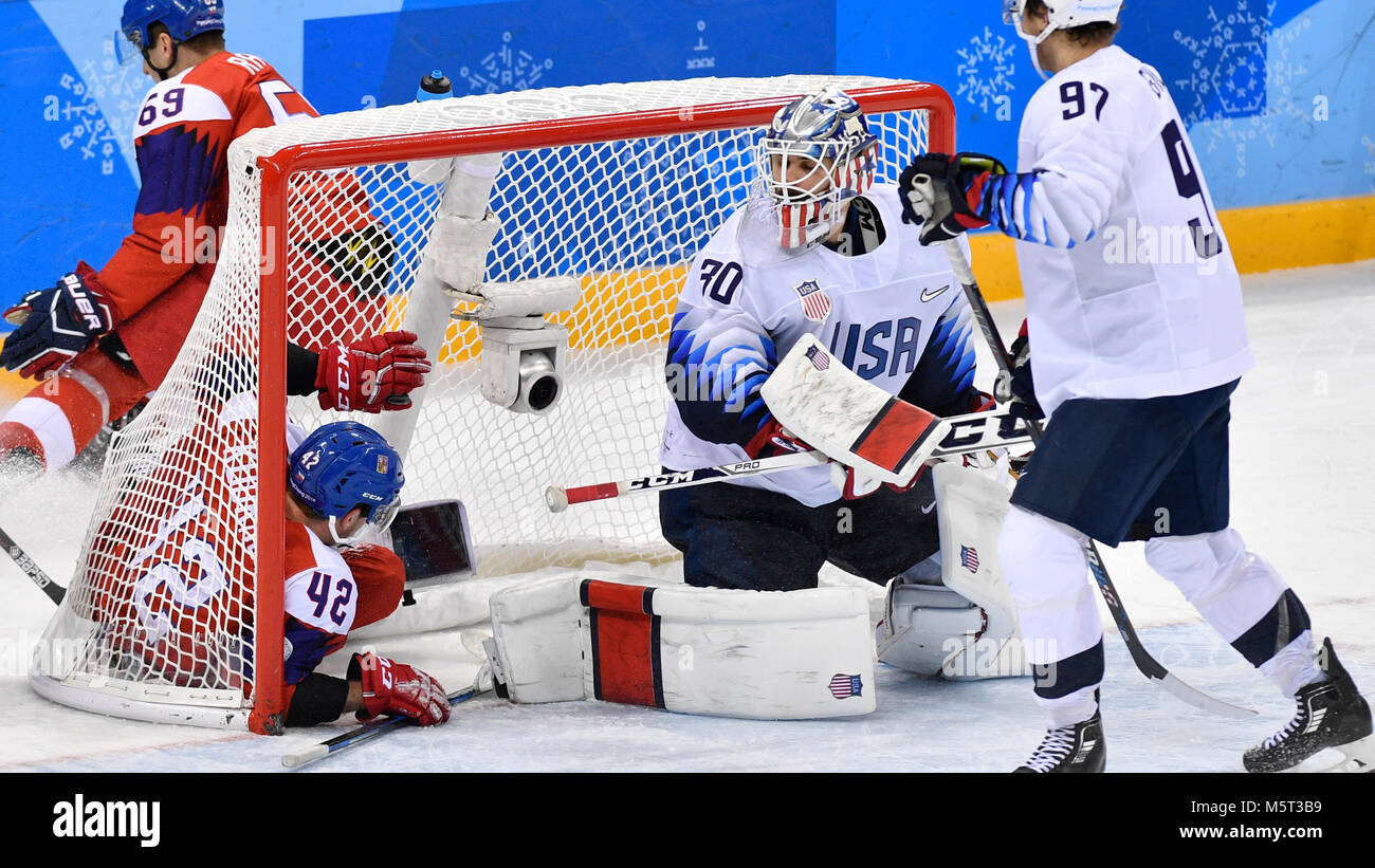 Czech PETR KOUKAL, left, and goalkeeper RYAN ZAPOLSKI of USA in US goalpost during the Czech Republic vs. USA quarterfinal ice-hockey match within the 2018 Winter Olympics in Gangneung, South Korea, February 21, 2018. (CTK Photo/Michal Kamaryt) Stock Photo