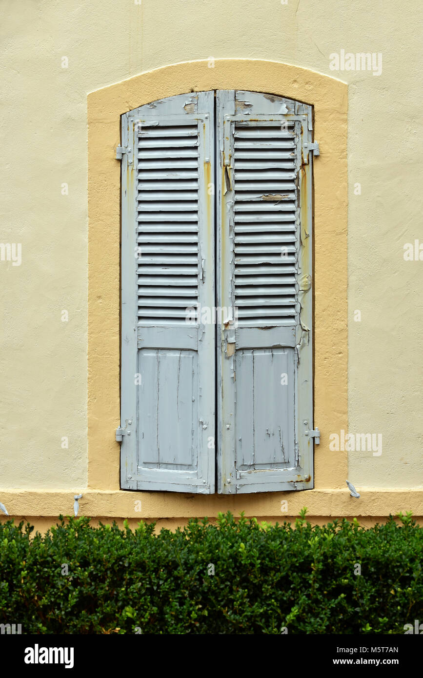Shutters in front of the window Stock Photo