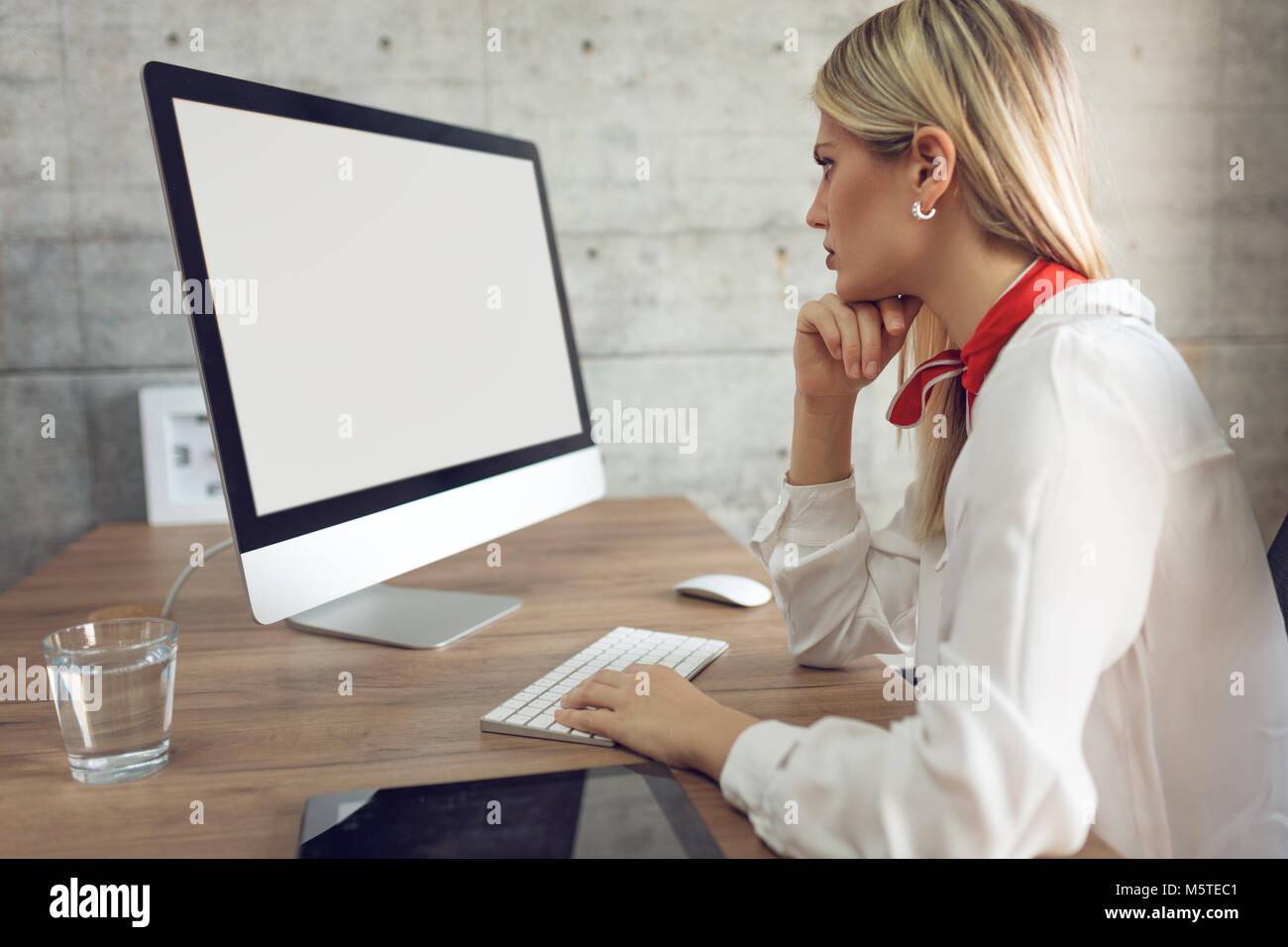 Young pensive business working on computer at the office Stock Photo ...