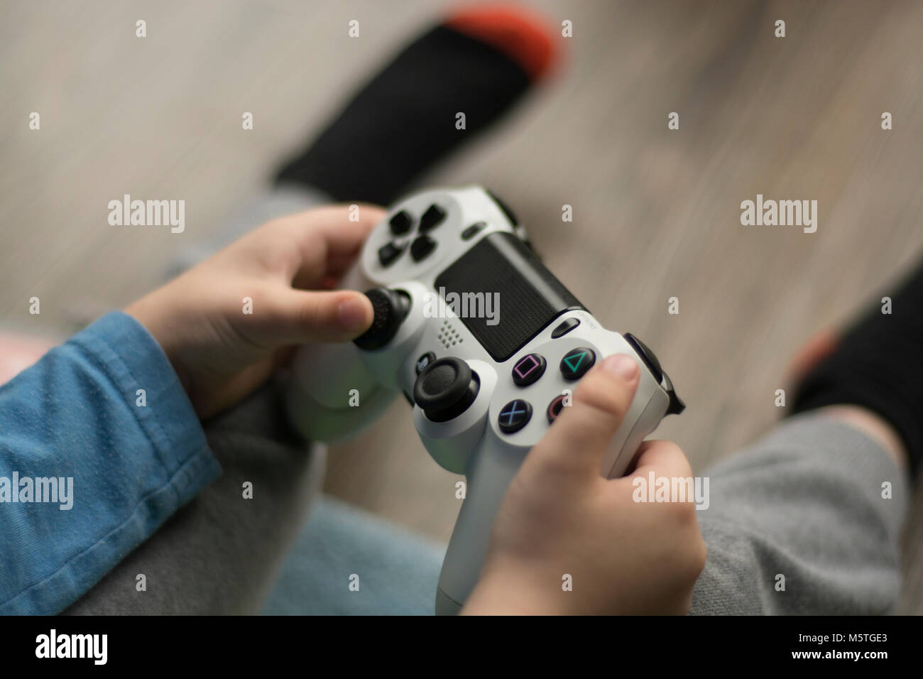 Young boy holding a PlayStation controller Stock Photo