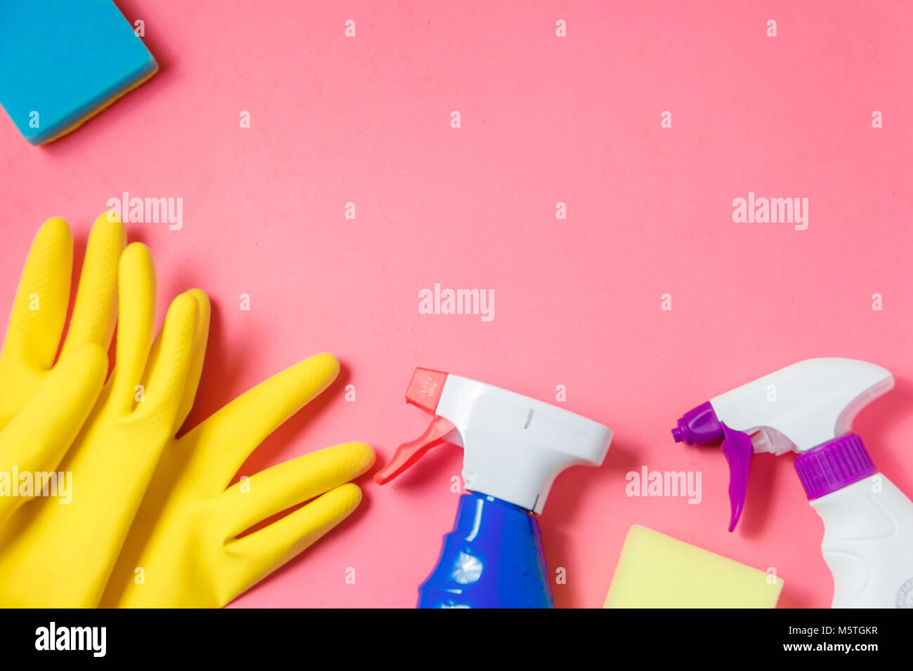 Cleaning Products. Home Cleaning Concept. Pink Background. Place for Typography and Logo. Copy space. Flat Lay. Top View Stock Photo