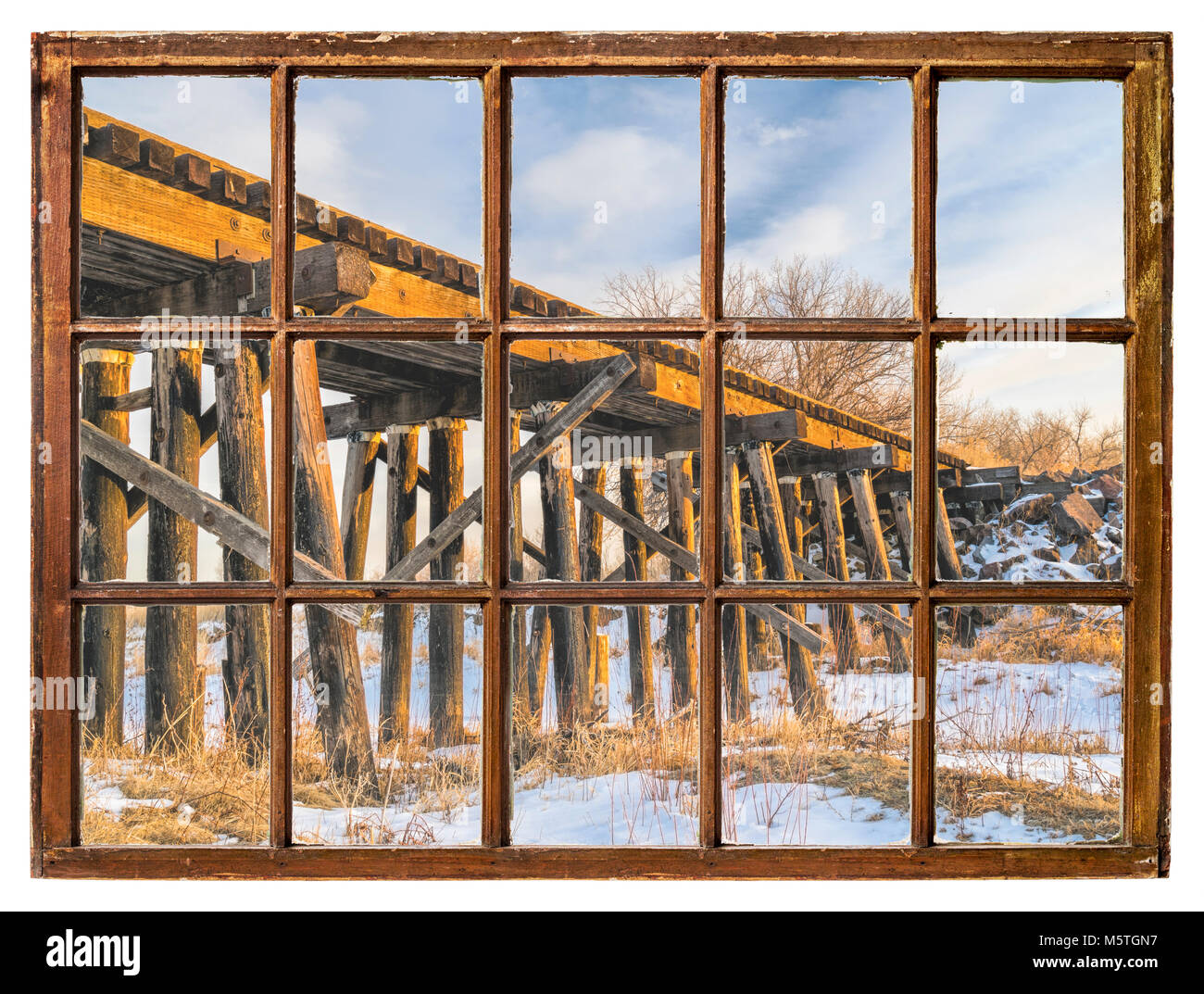 old railroad trestle as seen through vintage sash window with dirty glass Stock Photo