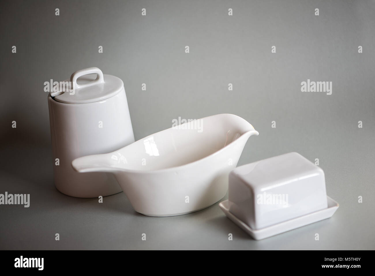 White dishes isolated on gray background Stock Photo Alamy