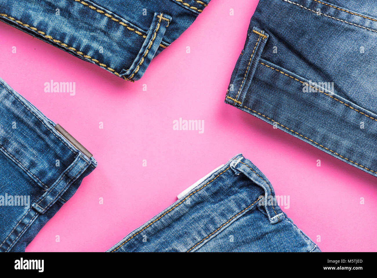 Jeans trousers flat lay on pink background. fashion and trends Stock ...