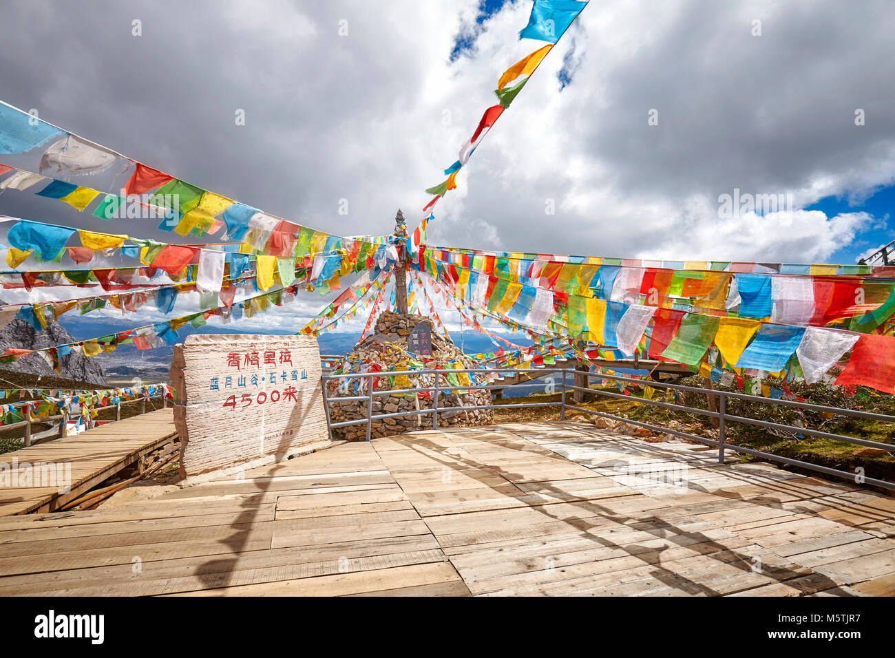 Top of the Shika Snow Mountain Scenic Area (4500 meters above the sea level) with Buddhist prayer flags, China. Stock Photo