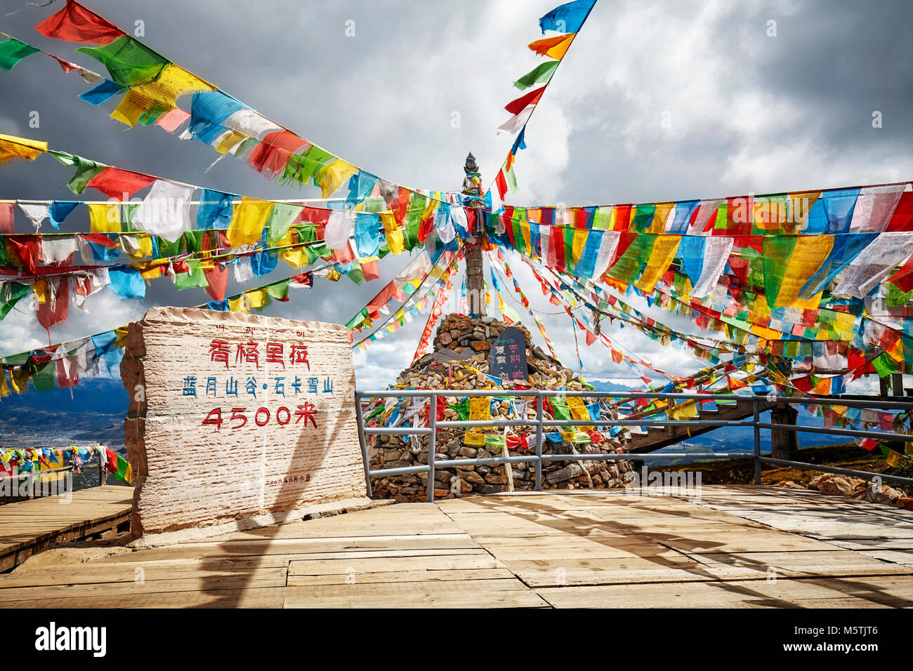 Top of the Shika Snow Mountain Scenic Area (4500 meters above the sea level) with Buddhist prayer flags, China. Stock Photo