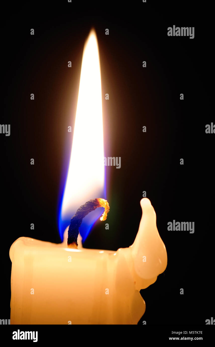 Candle with melted wax against dark background Stock Photo Alamy