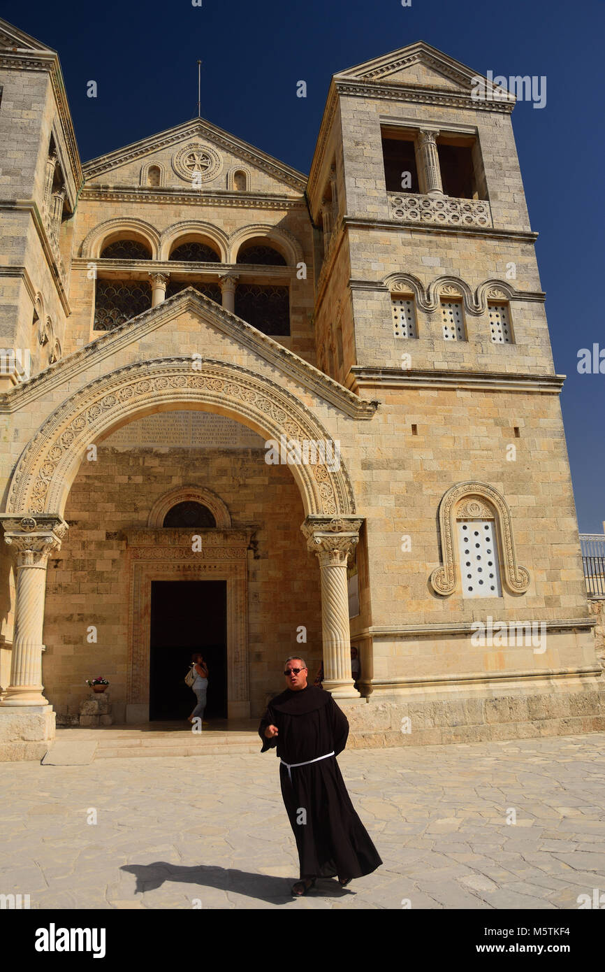 Priest walks in front of Franciscans monastery (Basilica of the Transfiguration) at the mount Tabor (Har Tavor) in northern Israel. Stock Photo