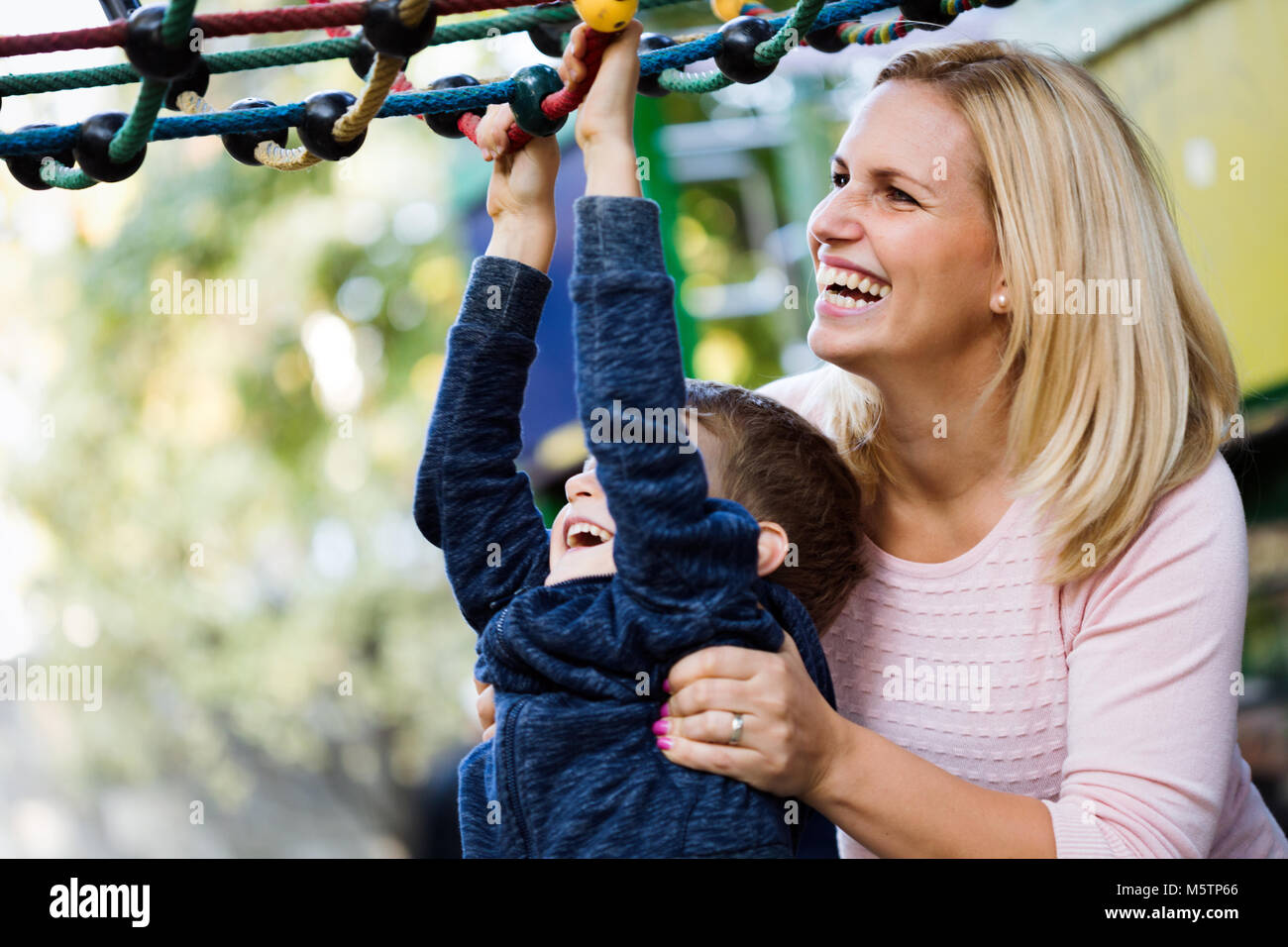 Mother and son having fun while playing in the park Stock Photo
