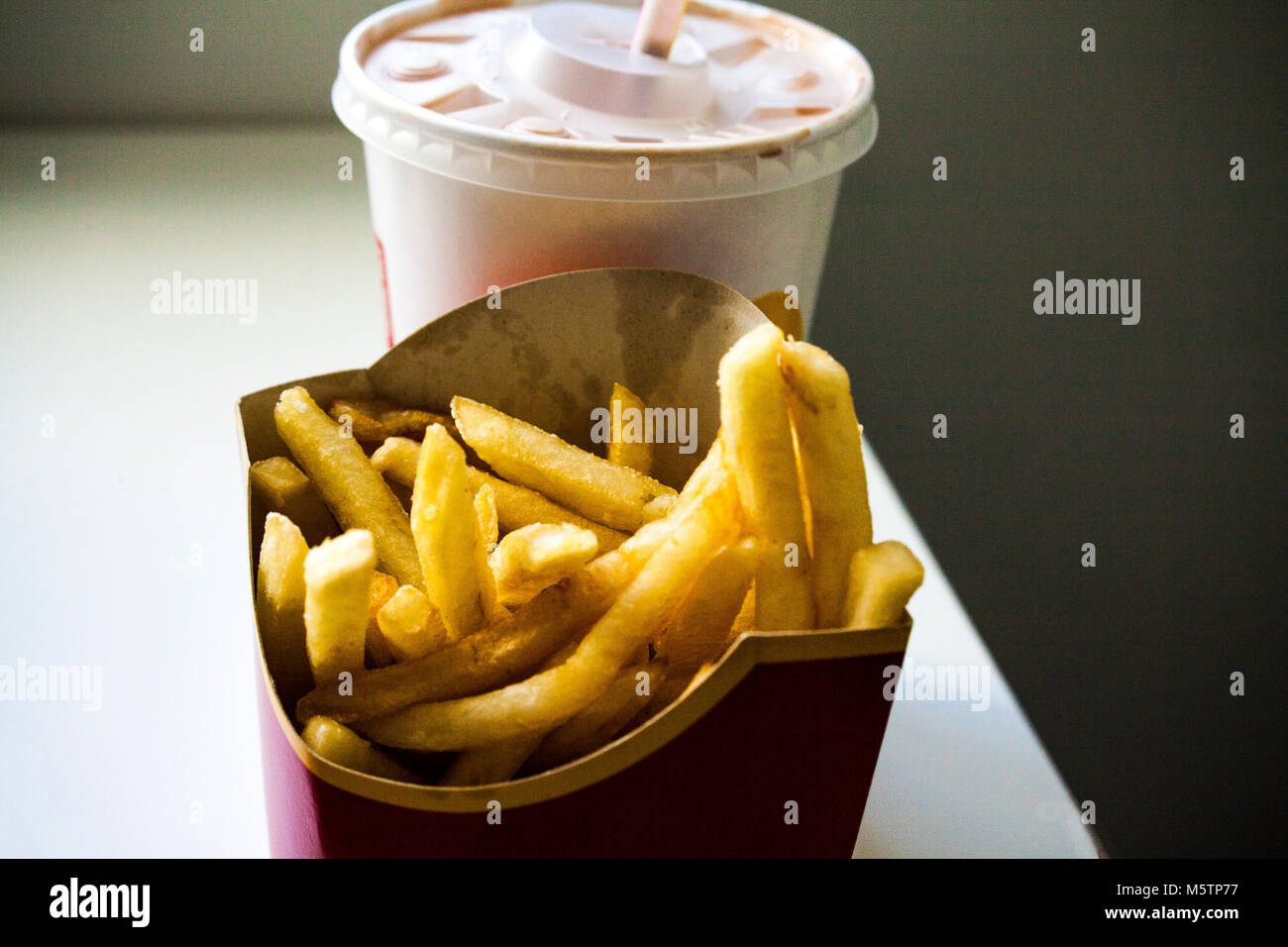 Drink and french fries on white background Stock Photo