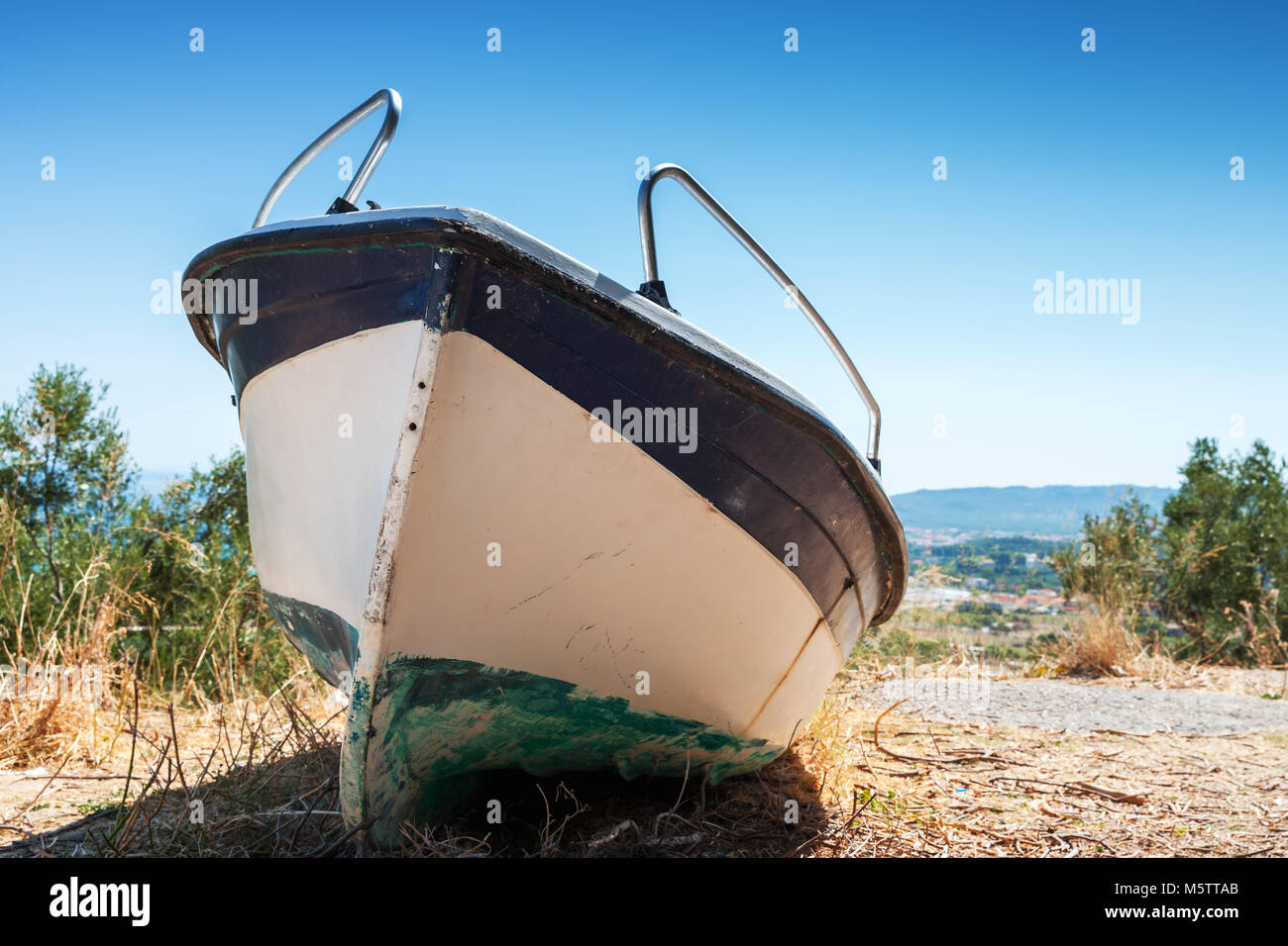 White fishing row boat on the coast. Summer landscape of Zakynthos island, Greece Stock Photo
