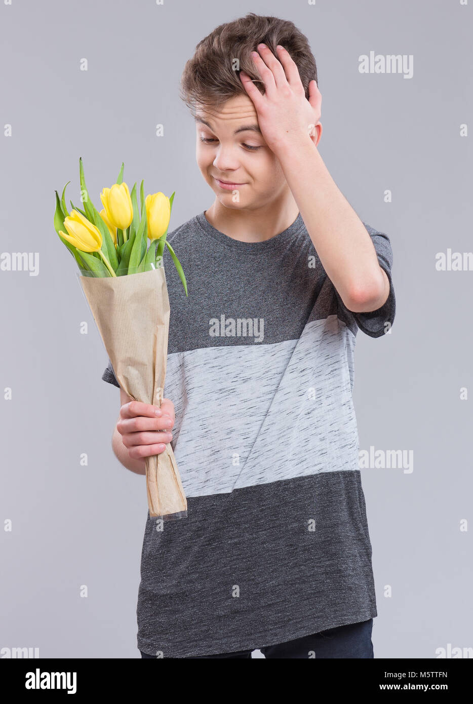 Teen boy with flowers Stock Photo Alamy