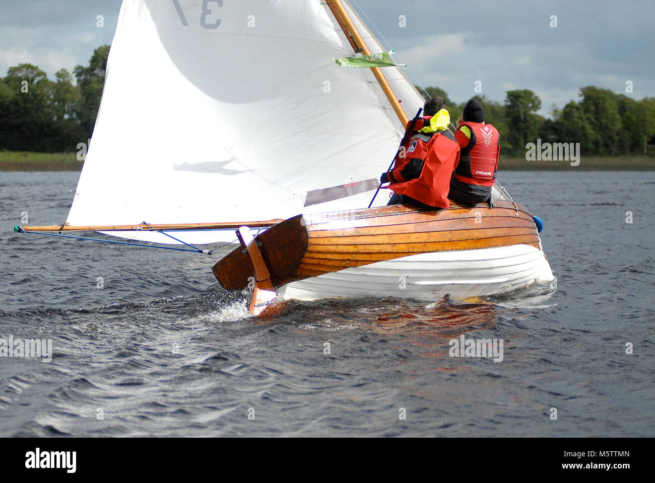 A Water Wag dinghy racing down the Shannon River towards Tarmonbarry in Ireland. (French sailors Sylvie Viant & Martine Gahinet-Charrier on board) Stock Photo