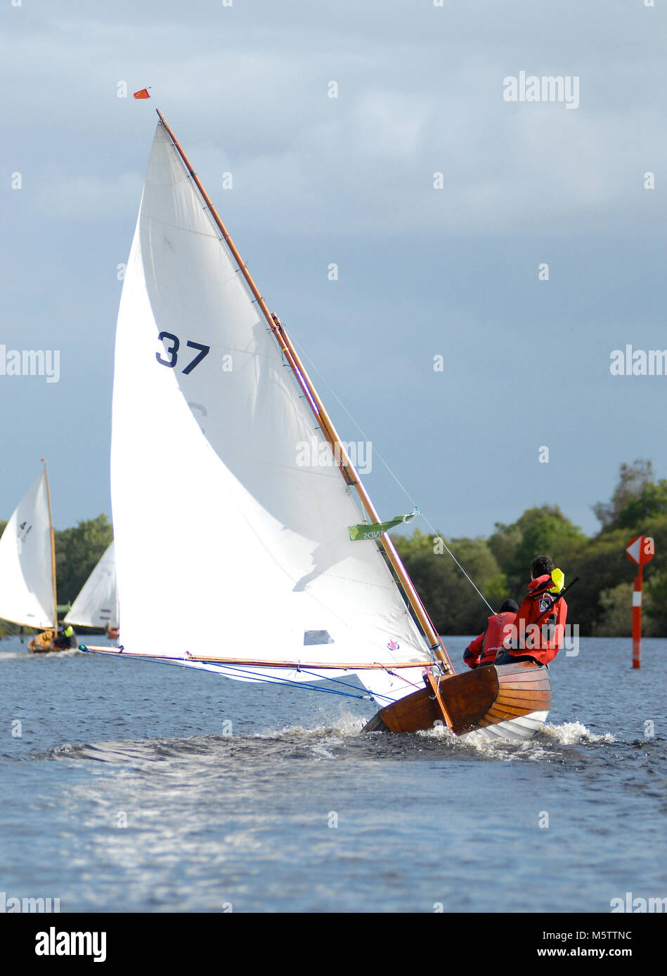 A Water Wag dinghy racing down the Shannon River towards Tarmonbarry in Ireland. (French sailors Sylvie Viant & Martine Gahinet-Charrier on board) Stock Photo