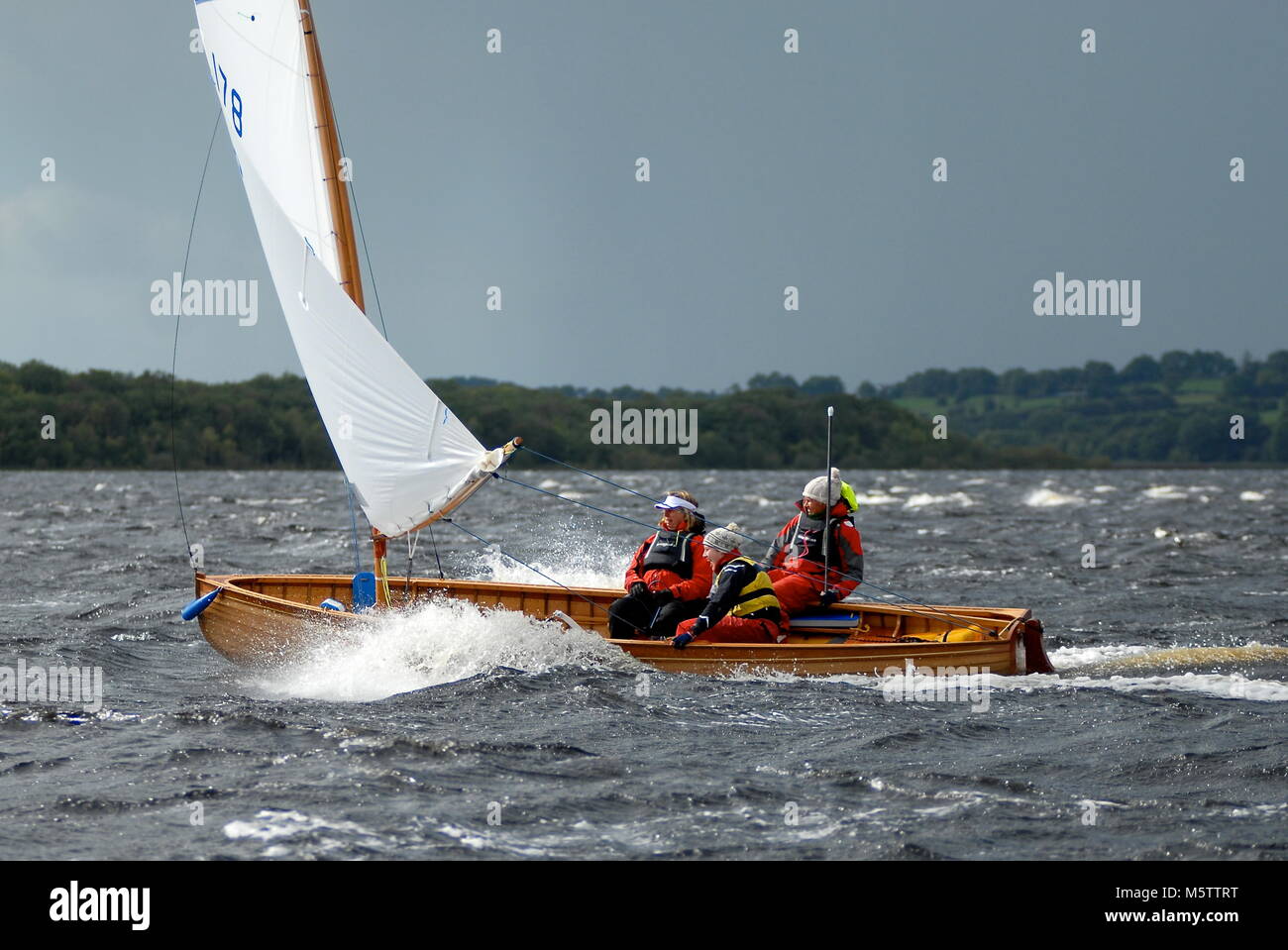 Olympic sailor Cathy MacAleavey (left) races her Shannon One Design down Lough Ree in 25 knots of wind during the Irish raid on the River Shannon. Stock Photo