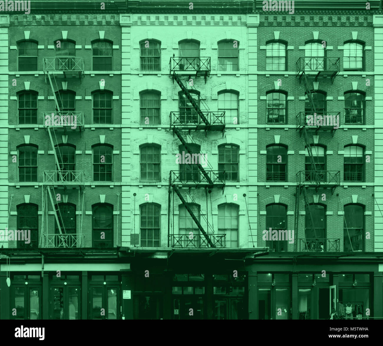 Pink and blue wall of windows on New York City buildings Stock Photo