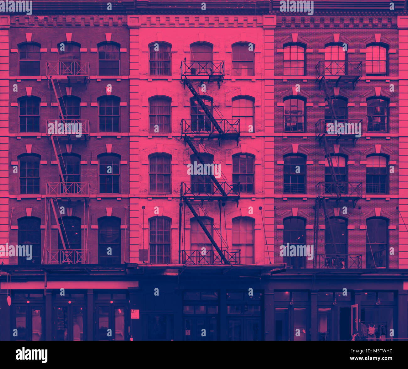 Pink and blue wall of windows on New York City buildings Stock Photo ...
