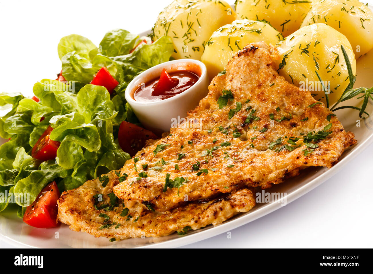 Fried pork chop and vegetables on white background Stock Photo - Alamy