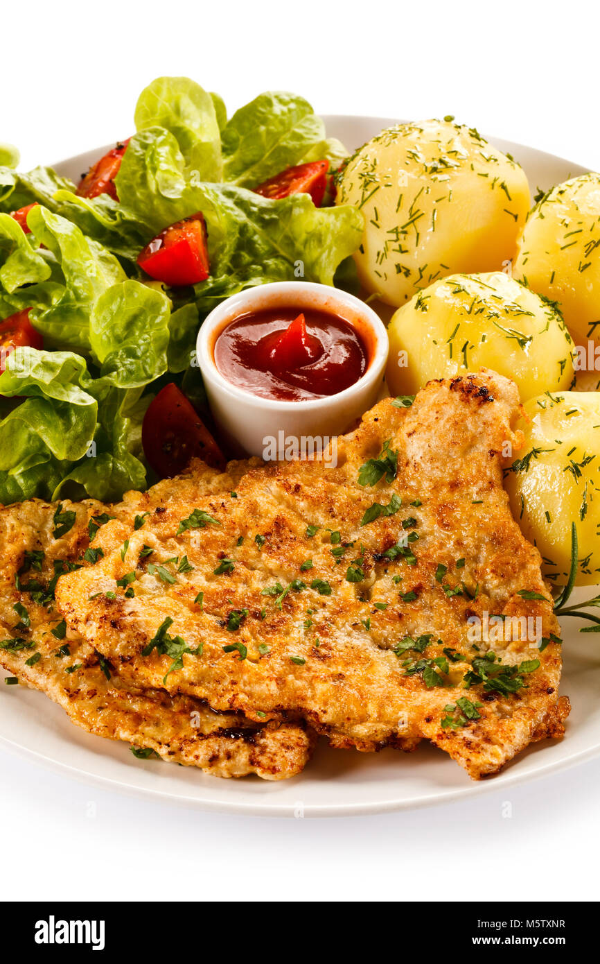 Fried pork chop and vegetables on white background Stock Photo - Alamy