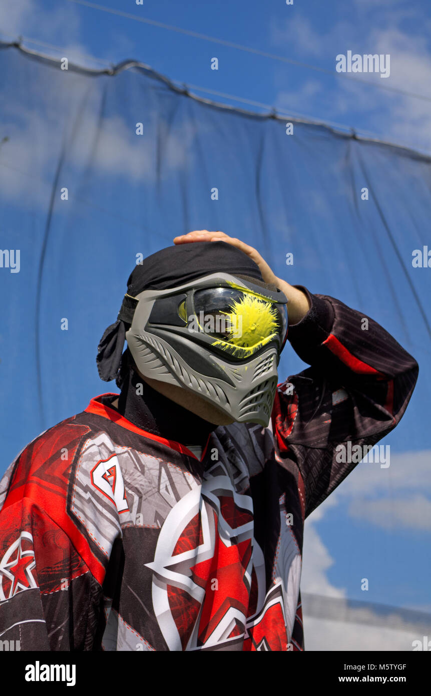 Paintball sport player with head shot by paint spot Stock Photo