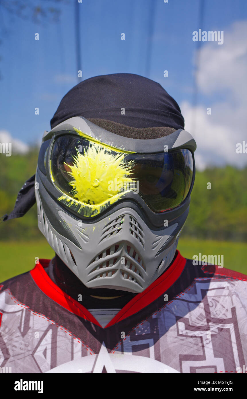 Paintball sport player with head shot by paint spot Stock Photo