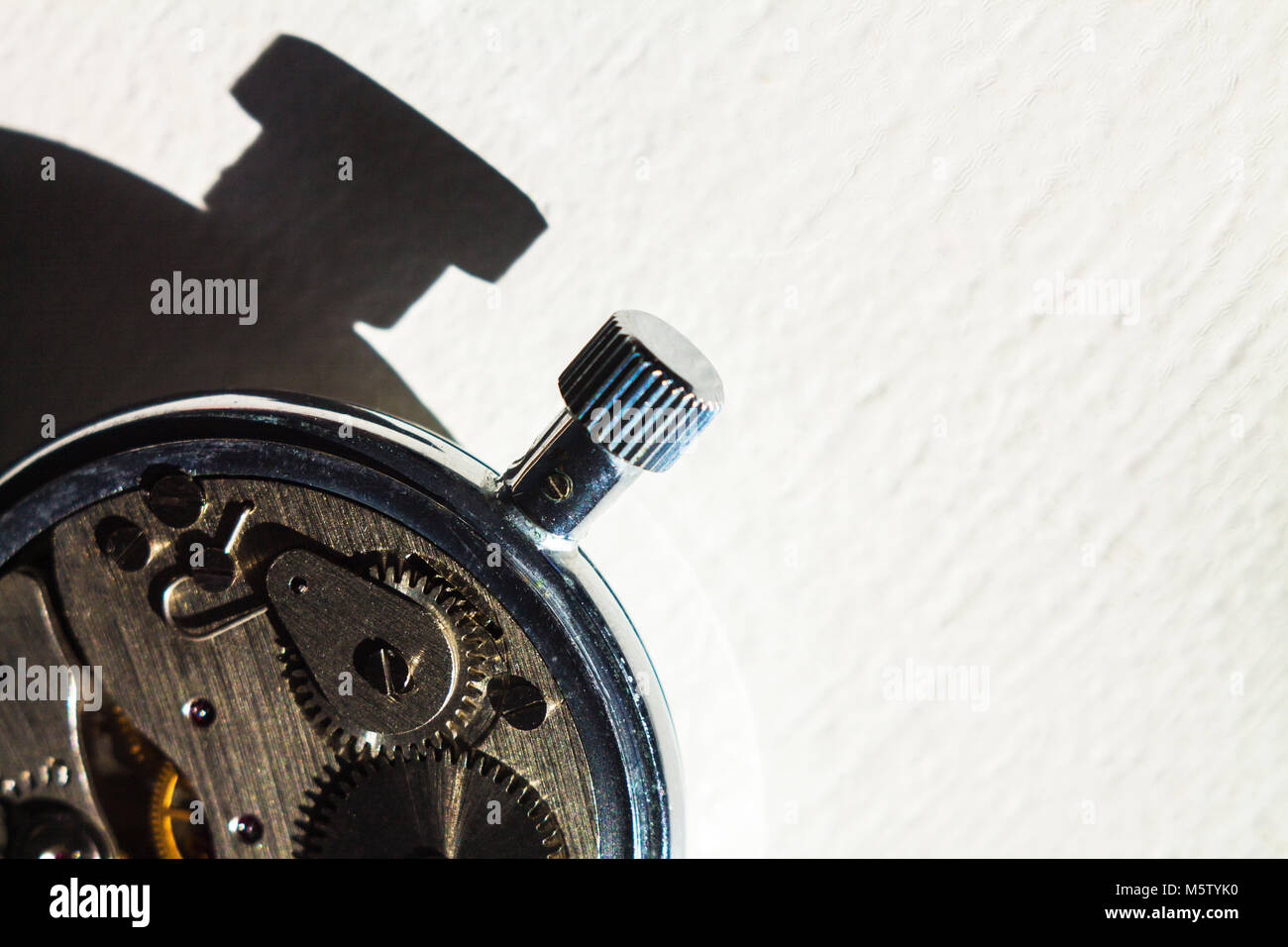 Open Back Watch Open back of old pocket watch with sidelight and contrasting shadow ...