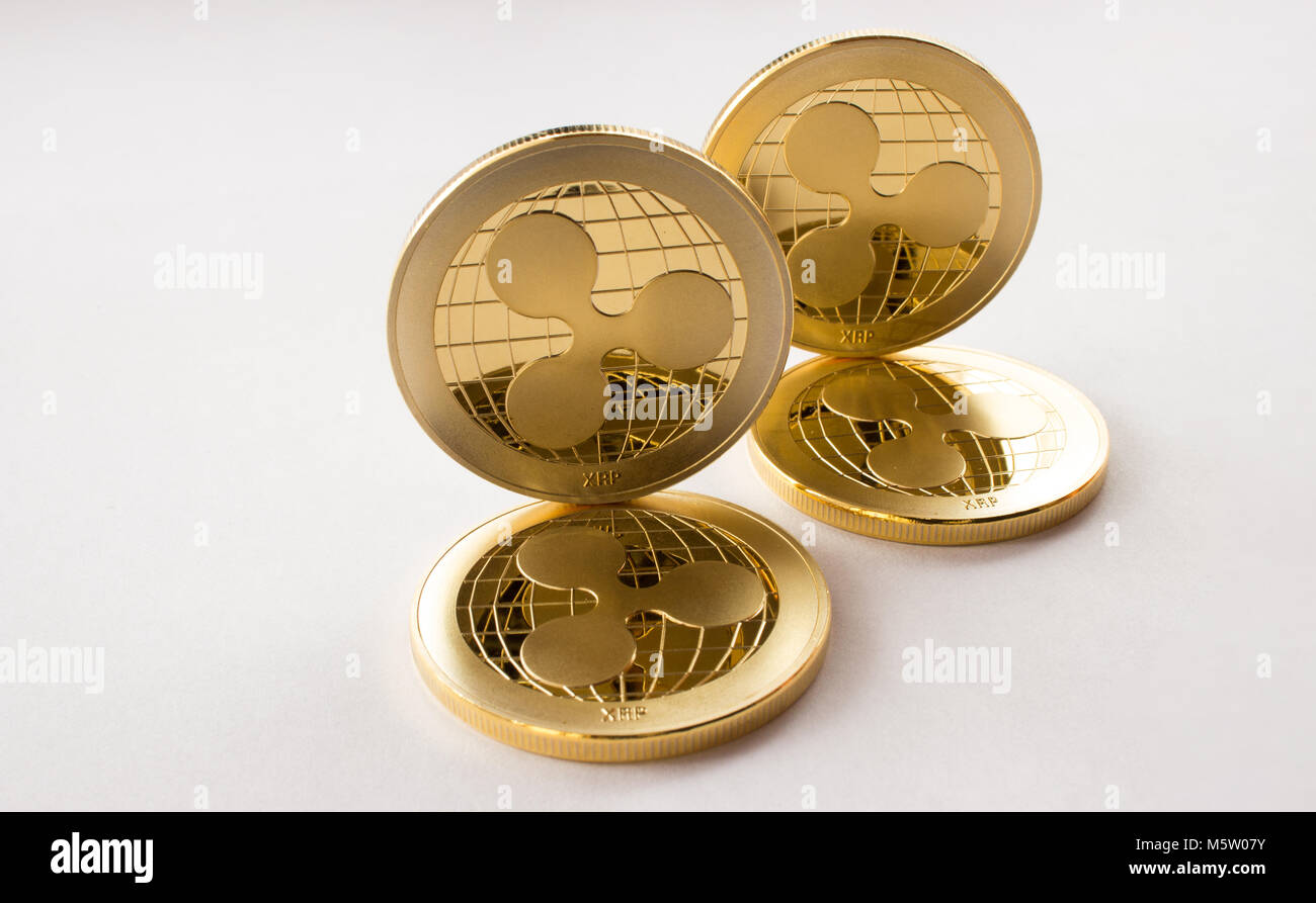 On the white background are gold coins of a digital virtual crypto currency  - ripple - xrp. In addition to the lying coins, there are standing ripple  Stock Photo - Alamy