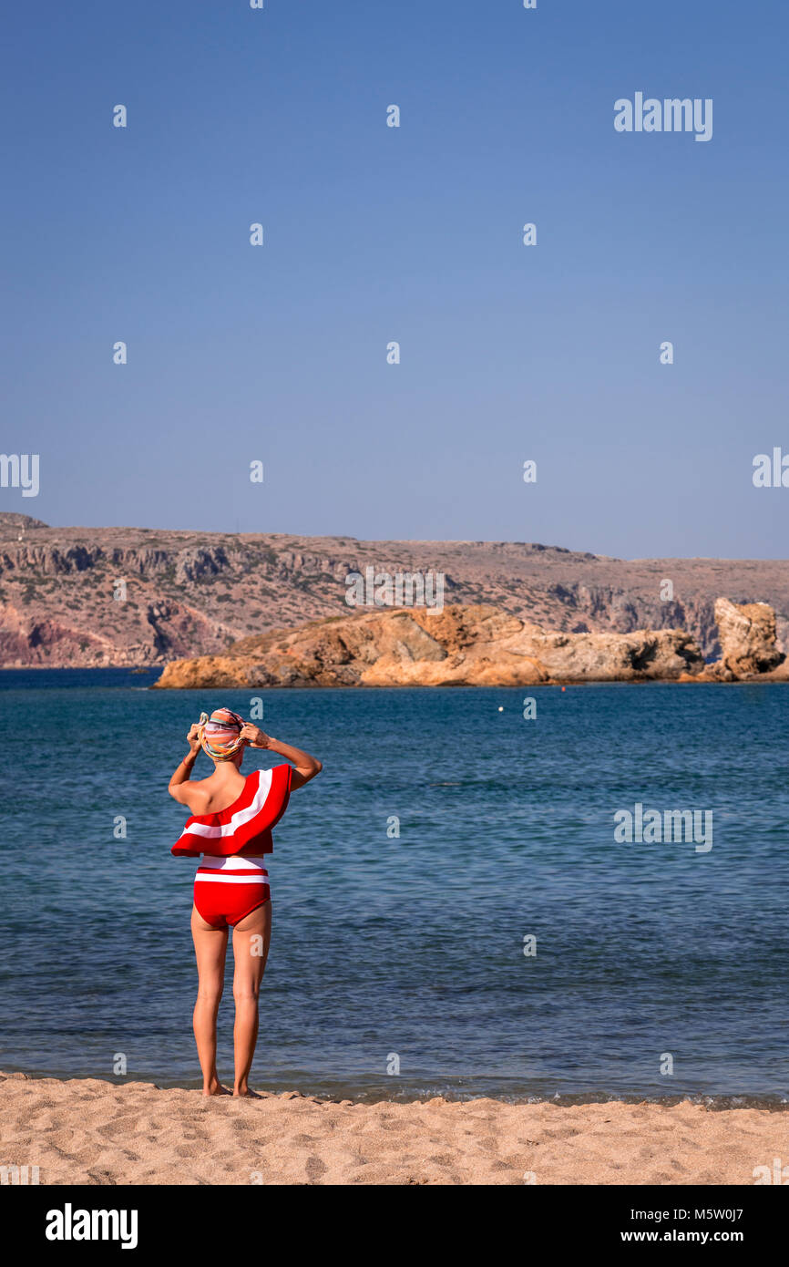 Girl in a red swimming costume at Vai on the Mediterranean island of Crete Stock Photo