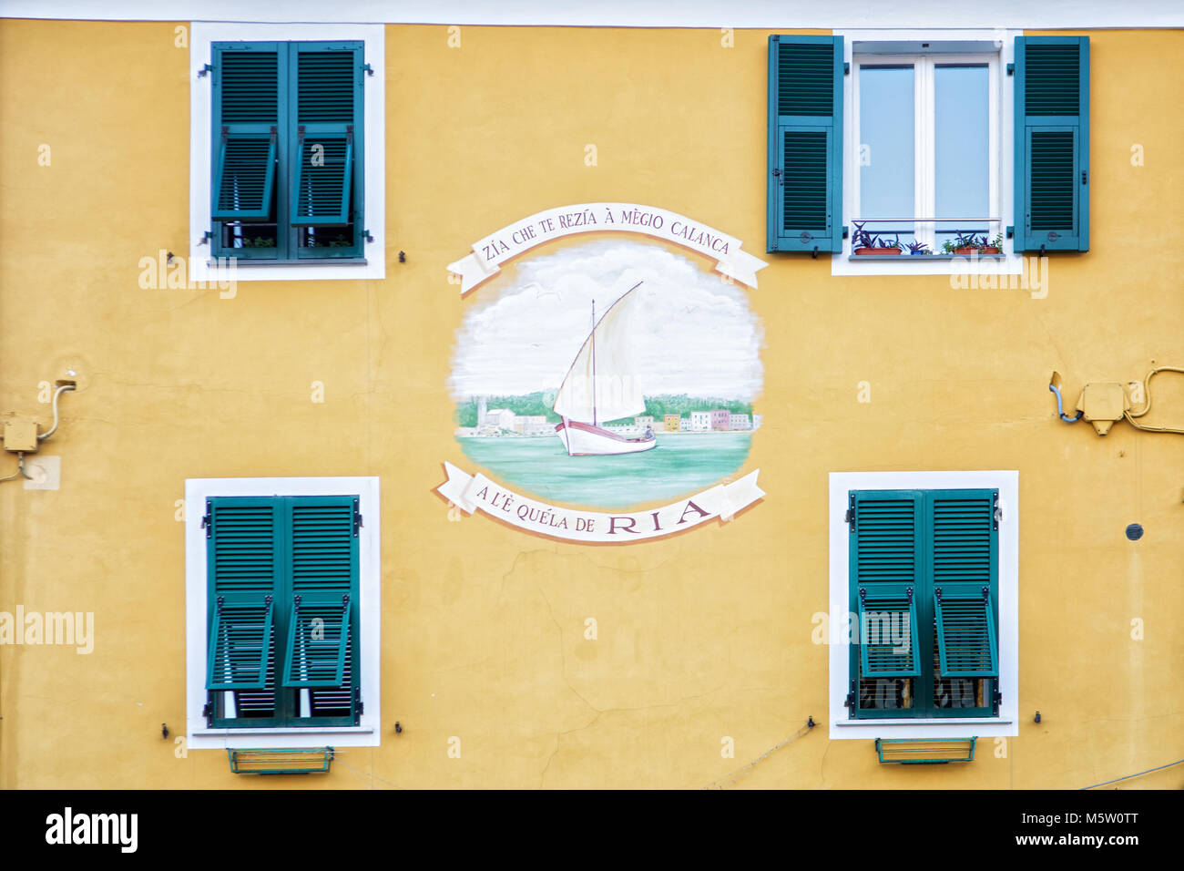 Yellow facade of a building in Le Grazie, Porto Venere, Liguria, Italy Stock Photo