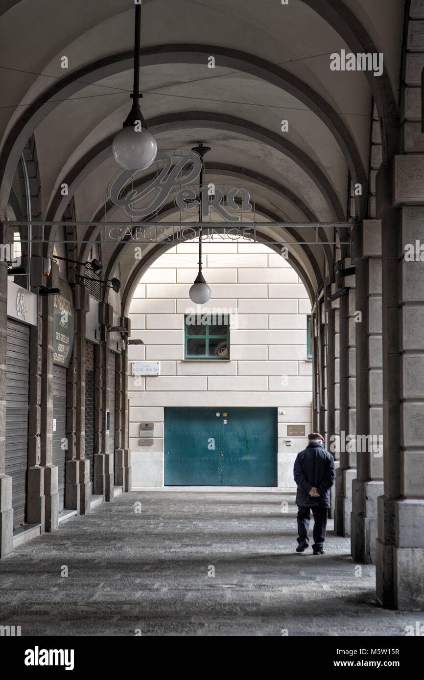Old man under the arcades in downtown Genoa, Liguria, Italy Stock Photo