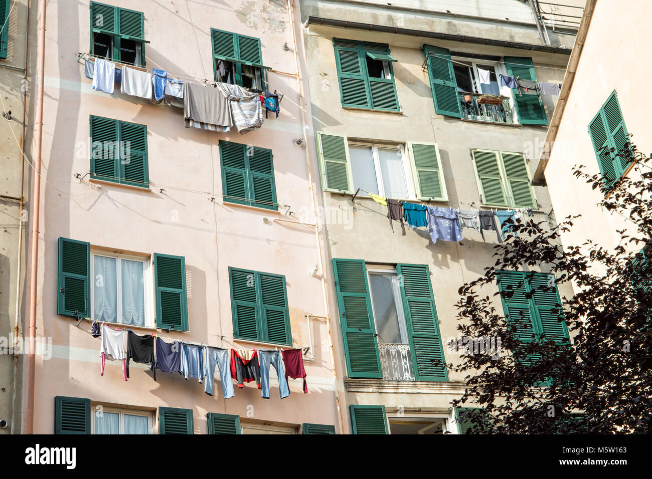 Laundry drying at the windows in the historical center of Genoa, Liguria, Italy Stock Photo