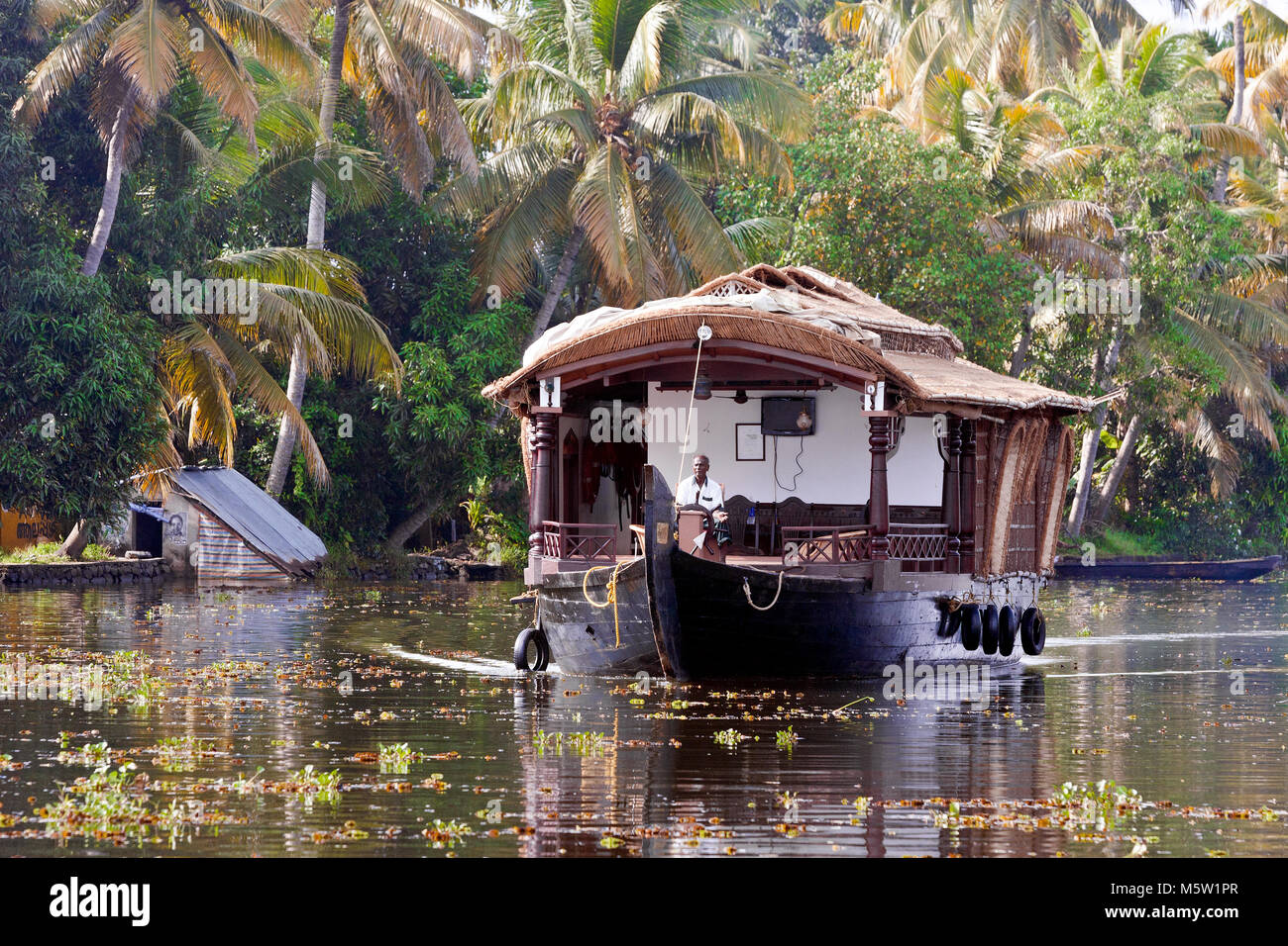 Sailing on a houseboat on the backwaters near Alleppey and Kumarakom in Kerala, India. Stock Photo