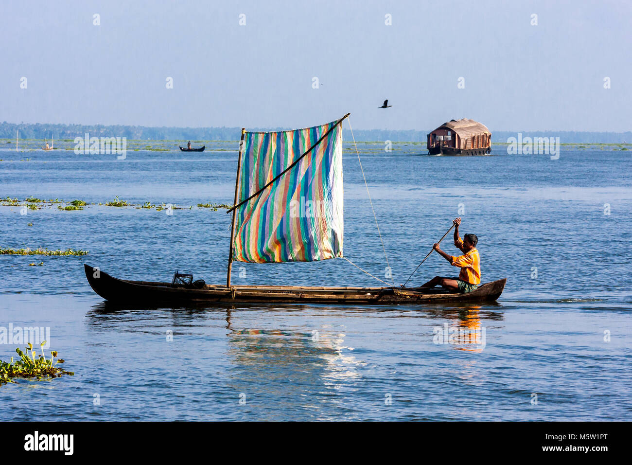Sailing on a canoe fitted with a sail. On Vembanad lake near Alleppey and Kumarakom in Kerala, India. Stock Photo