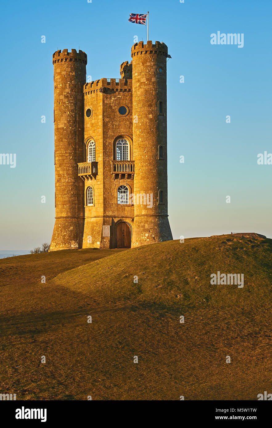 Broadway Tower, set on top of Fish Hill the second highest point in the Cotswolds, set against a clear blue late winter afternoon sky. Stock Photo