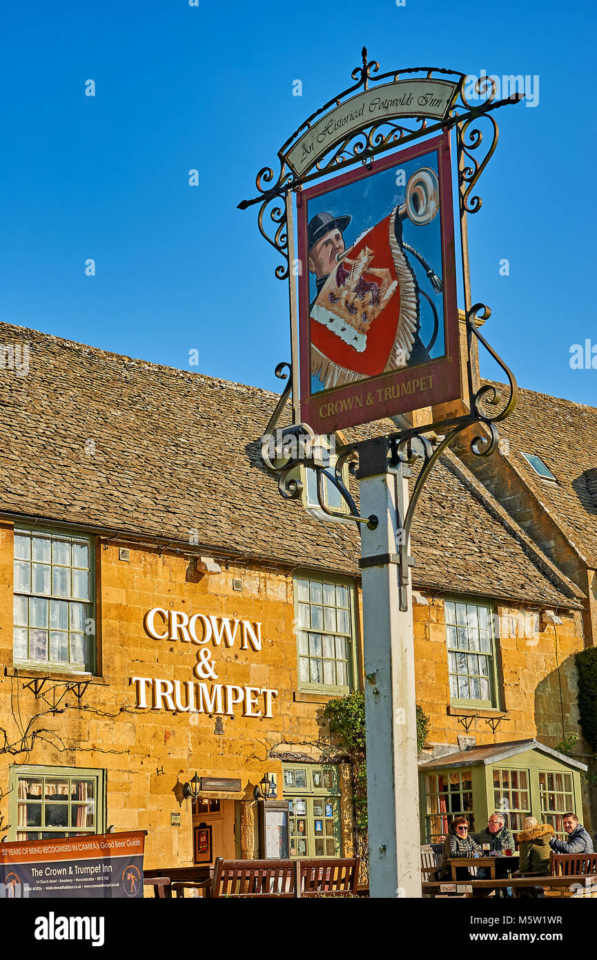 Old pub sign on a white post outside the Crown and Trumpet pub in the Cotswolds town of Broadway, England. Stock Photo