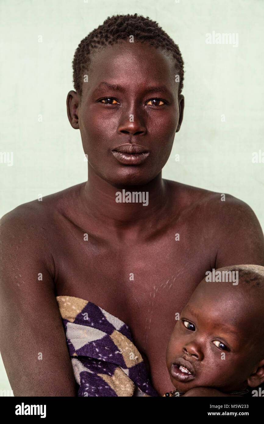 A Portrait Of A Woman and Baby From The Bodi Tribe, Bodi Village, Omo Valley, Ethiopia Stock Photo