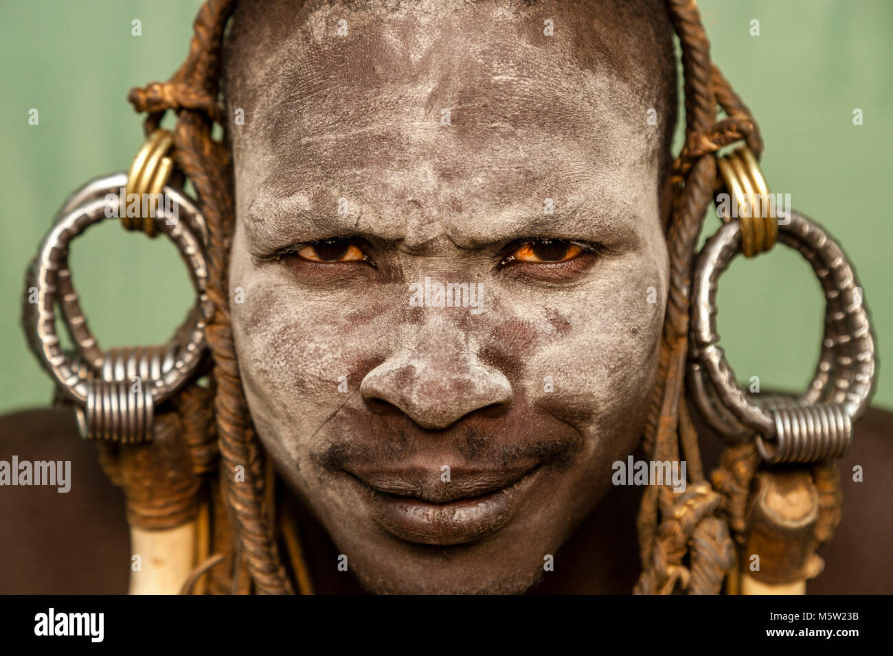 A Portrait Of A Young Man From The Mursi Tribe, Mursi Village, Omo Valley, Ethiopia Stock Photo